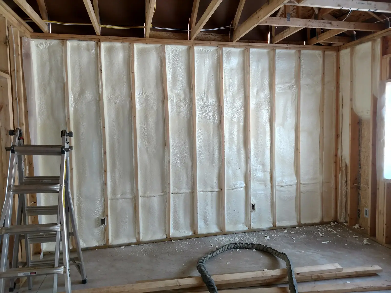 Closed-cell spray foam filling a framed wall