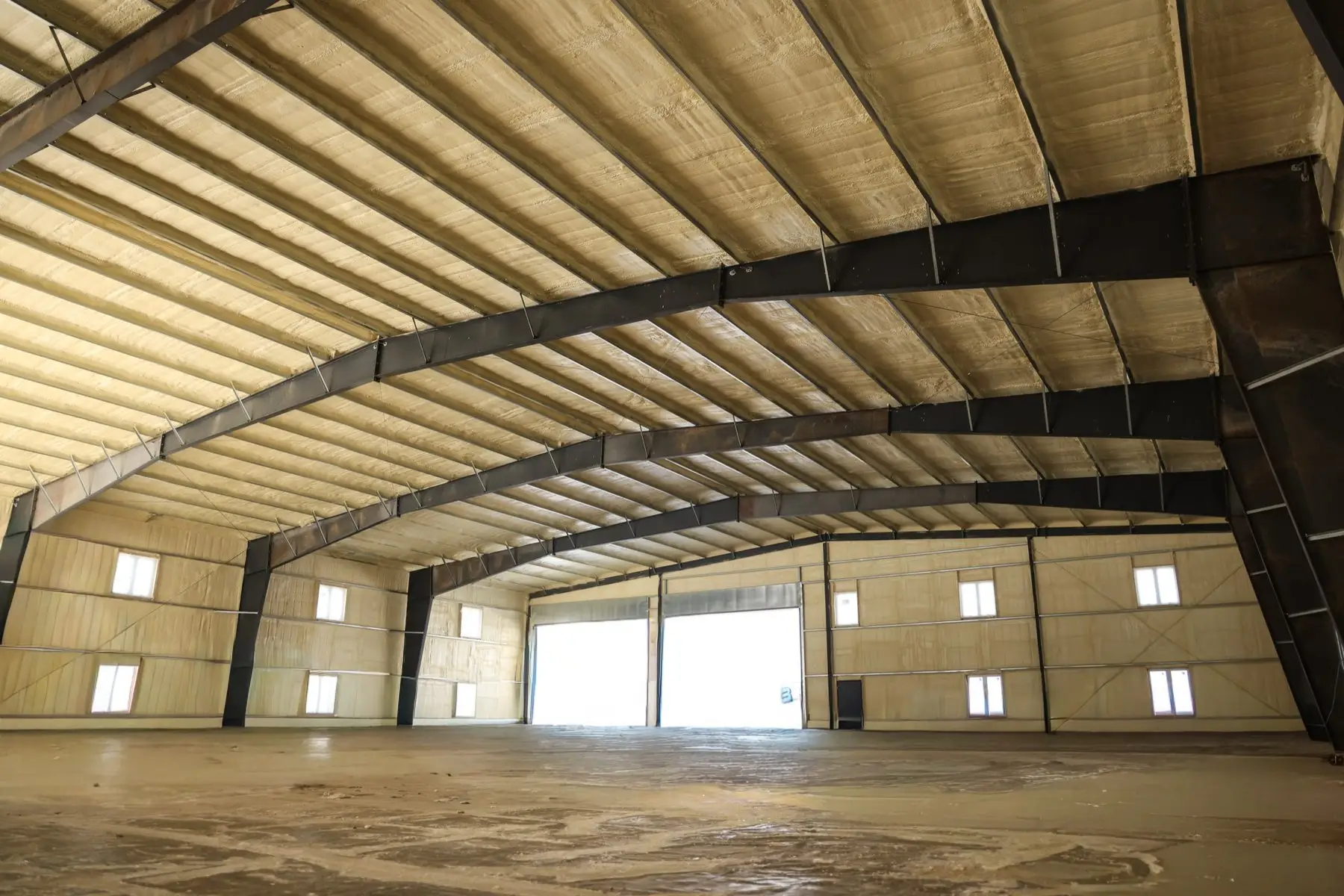 Steel-frame warehouse with sprayed roof and walls